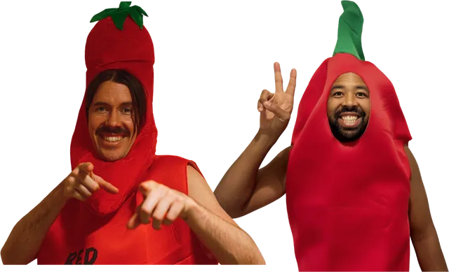 Mitchell and Takashi of Spice Agency smiling in red chili pepper costumes, one pointing at the camera and one giving a peace sign